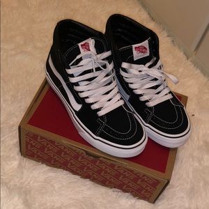 Black and White High-Top Vans.